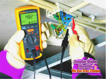 Fluke insulation tester reading megohms in a real Houston panel